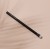 Na zdjęciu widoczny jest pędzel INIKA Organic Blending Brush, przeznaczony do blendowania cieni do powiek. Pędzel ma smukły, czarny trzonek z białym napisem i zaokrąglone, miękkie włosie w odcieniach bieli i czerni. Produkt jest na beżowym tle