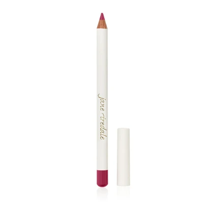 Na zdjęciu kredka do ust Jane Iredale. Ma elegancki, biały korpus z logo marki oraz kolorową końcówkę odpowiadającą odcieniowi kredki. To uniwersalne kredki, które mogą być używane zarówno do konturowania ust, jak i do całkowitego ich wypełnienia