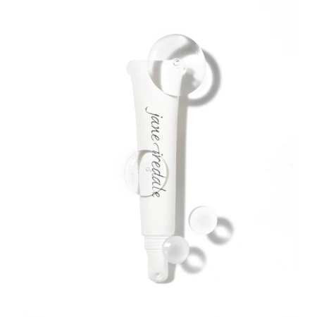 Na zdjęciu znajduje się kosmetyk marki Jane Iredale w postaci przezroczystego żelu, zamknięty w smukłej, białej tubce z aplikatorem typu „roll-on” lub precyzyjną końcówką. Opakowanie ma minimalistyczny design z eleganckim logotypem marki.