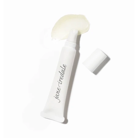 Na zdjęciu widoczna jest otwarta tubka kosmetyku marki Jane Iredale, z której wydobyto niewielką ilość produktu w postaci przezroczysto-żelowego balsamu o lekko żółtawym odcieniu. Opakowanie ma minimalistyczny design