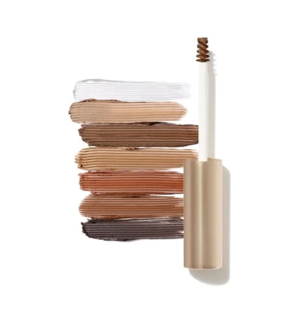 Żel do brwi jane iredale PureBrow® Brow Gel.  Smukłe, opakowanie ze złotą zakrętką. Mała, spiralka szczoteczki umożliwia dokładną aplikację i modelowanie brwi.  Na zdjęciu widoczne są próbki odcieni produktu – od przezroczystego po różne warianty brązów.