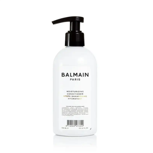Biała butelka z czarną pompką zawierająca odżywkę nawilżającą Balmain Paris Moisturizing Conditioner. Minimalistyczny design z czarnym napisem, produkt o pojemności 300 ml. Profesjonalna pielęgnacja do suchych lub farbowanych włosów.