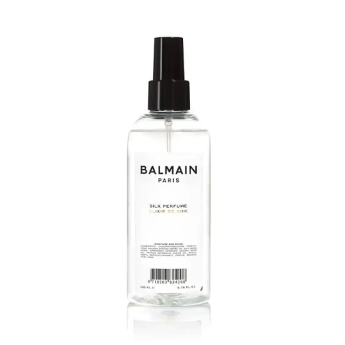 Perfumy do włosów Balmain Paris Silk Perfume w przezroczystej butelce z czarnym atomizerem. Minimalistyczny design z czarnym napisem na białym tle.