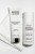Na białym ręczniku stoją dwa produkty Instytutum: Transforming Melting Cleanser w tubce (oczyszczająco-nawilżający żel) i Retinol Toner w butelce z pompką (tonik wygładzający z retinolem). Opakowania białe z czarnym i fioletowym tekstem.