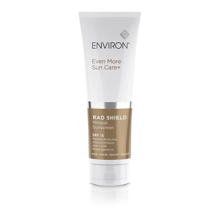 Tubka kremu Environ RAD Shield Mineral Sunscreen w kolorze białym z brązowo białą etykietą i szarym napisem, przeznaczona do ochrony przeciwsłonecznej.