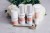 Zdjęcie wszystkich produktów z linii Environ Focus Care Radiance, stojących na tle kwiatów, na marmurowej powierzchni. Przed produktami leży złoty Roll Cit.