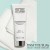 Biała tubka Instytutum Transforming Melting Cleanser leży na białym ręczniku, na tle w kolorze miętowym. Produkt oczyszczający i nawilżający z kwasem hialuronowym, olejem migdałowym i witaminami. W prawym dolnym rogu logo marki Instytutum.
