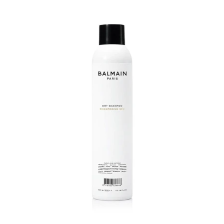 Biała butelka z czarną nakrętką zawierająca suchy szampon marki Balmain Paris o pojemności 300 ml. Minimalistyczny design – czarne napisy na białym tle, w tym logo i opis produktu „Dry Shampoo”.