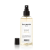 Balmain Paris Texturizing Salt Spray w przezroczystej, lekko żółtawej butelce z czarnym atomizerem. Minimalistyczna etykieta z czarnym napisem.