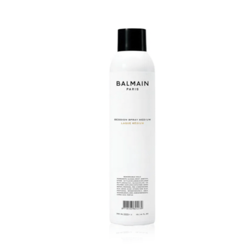 Biała butelka lakieru do włosów Balmain Paris Session Spray Medium z czarną nakrętką. Minimalistyczny design, czarne litery na białym tle