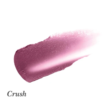 Na grafice widoczna jest próbka koloru szminki lub balsamu do ust marki Jane Iredale w odcieniu Crush. To chłodny, głęboki róż wpadający w śliwkę, z subtelnym połyskiem. Konsystencja wygląda na kremową i gładką