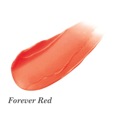Na zdjęciu znajduje się próbka koloru produktu Jane Iredale Just Kissed Lip & Cheek Stain w odcieniu Forever Red.  Kolor to ciepła, półtransparentna czerwień z delikatnym połyskiem