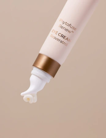 zdjęcie przedstawia zbliżenie na końcówkę tubki kremu pod oczy INIKA Organic Phytofuse Renew Eye Cream Produkt posiada aplikator o ergonomicznym kształcie, zakończony białą, masującą końcówką, przez którą wydobywa się niewielka ilość kremu