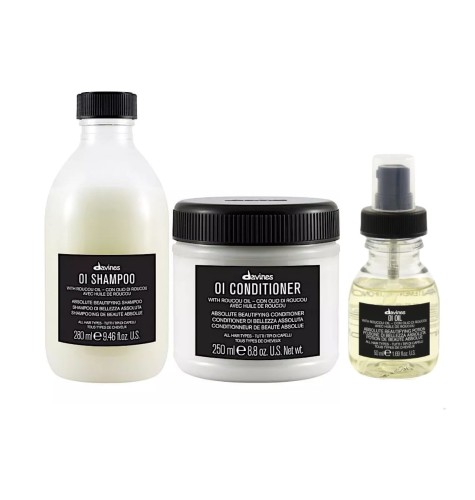 Zestaw kosmetyków do włosów Davines OI: szampon (280 ml), odżywka (250 ml) oraz olejek OI Oil w buteleczce z pompką. Wszystkie produkty w eleganckich opakowaniach z czarnymi etykietami.