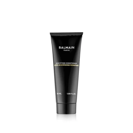 Na zdjęciu znajduje się odżywka do włosów marki Balmain Paris – Bodifying Conditioner. Produkt umieszczony jest w eleganckiej, czarnej tubce o minimalistycznym designie, z białym nadrukiem.