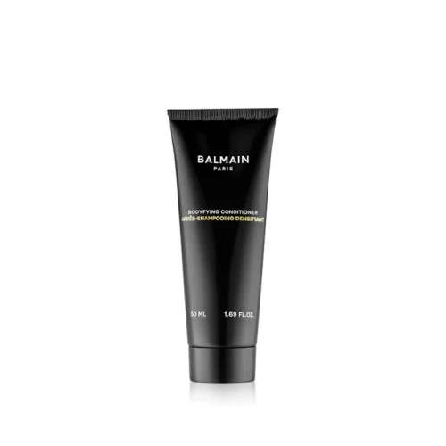 Na zdjęciu znajduje się odżywka do włosów marki Balmain Paris – Bodifying Conditioner. Produkt umieszczony jest w eleganckiej, czarnej tubce o minimalistycznym designie, z białym nadrukiem.