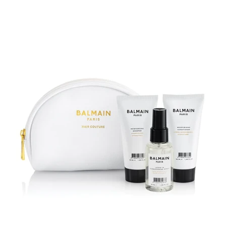 Zestaw BALMAIN Paris Moisturizing Set – komplet nawilżających kosmetyków do włosów w mini wersjach podróżnych 50 ml. Butelki o minimalistycznym, biało-czarnym designie z logo BALMAIN i biało złota kosmetyczka