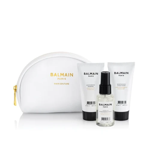 Zestaw BALMAIN Paris Moisturizing Set – komplet nawilżających kosmetyków do włosów w mini wersjach podróżnych 50 ml. Butelki o minimalistycznym, biało-czarnym designie z logo BALMAIN i biało złota kosmetyczka