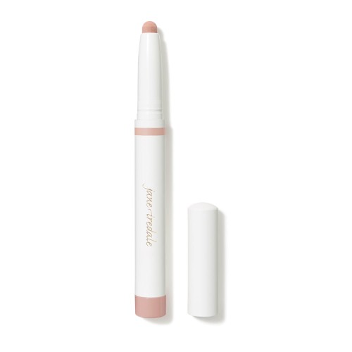 Na zdjęciu widoczna jest biała kredka eye shadow stick  automatyczne cienie do powiek w sztyfcie marki Jane Iredale, z lekko różowymi elementami.