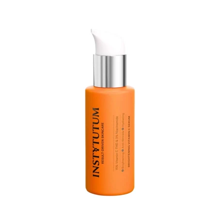 Na zdjęciu znajduje się produkt pielęgnacyjny marki Instytutum Brightening Vitamin C Serum w eleganckiej, pomarańczowej butelce z pompką.png