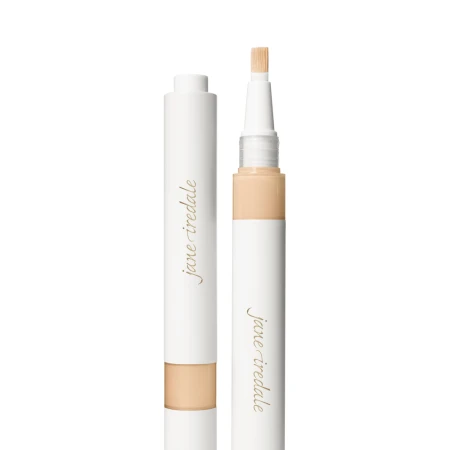Na zdjęciu znajduje się korektor w pędzelku marki jane iredale – Skintuition Brightening Under Eye Concealer. Widać opakowanie typu twist z wbudowanym aplikatorem-pędzelkiem oraz zatyczkę. Produkt służy do rozświetlania i maskowania cieni pod oczami.