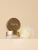 Na zdjęciu widoczne są otwarte słoiczki maski do ust INIKA Organic Lip Mask Bakuchiol + AHA, prezentujące odżywczą formułę wzbogaconą bakuchiolem, kwasami AHA i ceramidami na eleganckim, beżowym tle.
