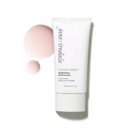 Na zdjęciu znajduje się produkt Smooth Affair Brightening w białej tubce o pojemności 50 ml. Obok pokazano różowy odcień i kremową konsystencję produktu.